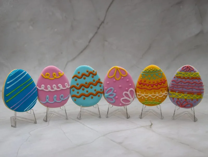 Easter Egg Wonderland Cookies with vibrant royal icing decorations, standing vertically.