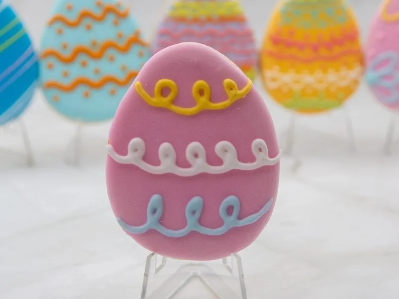 Close-up of an individual Easter Egg Wonderland Cookie with purple icing and detailed line work.