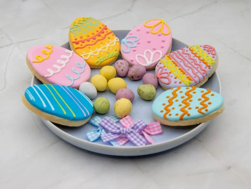 Easter Egg Wonderland Cookies with colourful decorations styled in an Easter-themed setup.