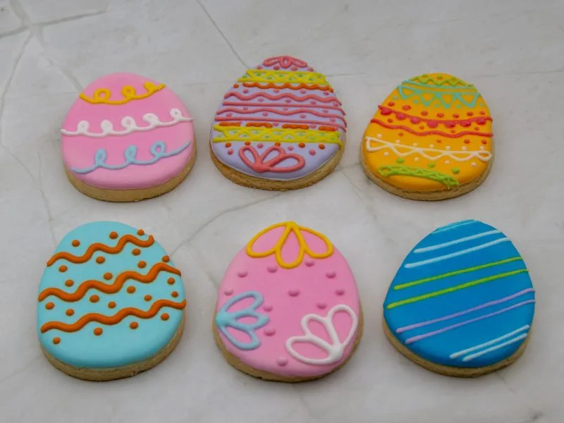 Easter Egg Wonderland Cookies arranged with colourful icing, laid flat on the surface.
