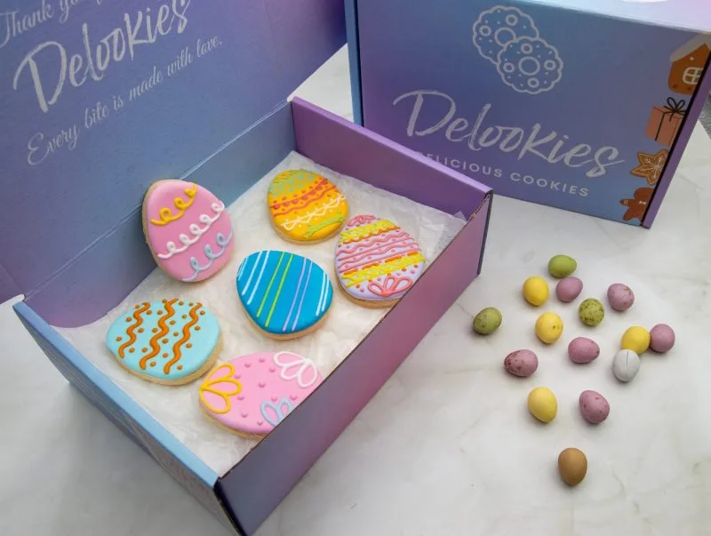Easter Egg Wonderland Cookies in a gift box with bright, colourful royal icing decorations.