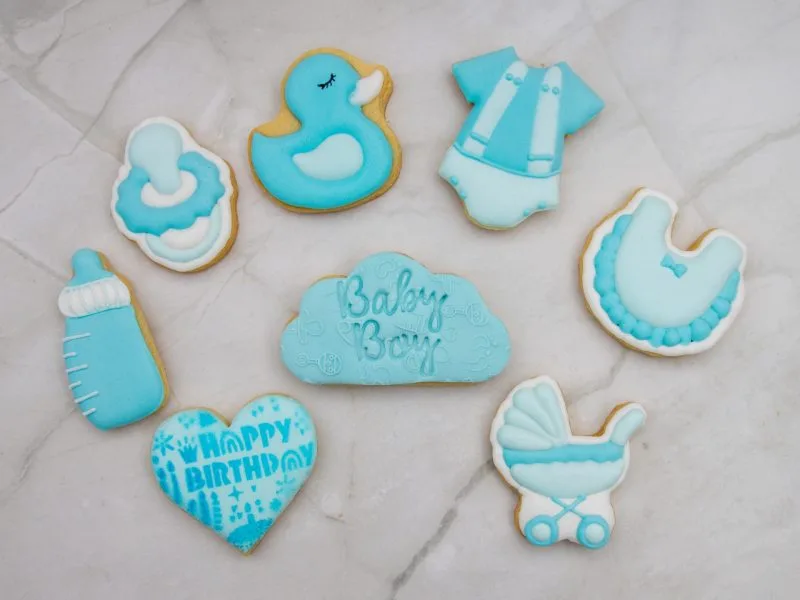 Flat lay of blue baby boy themed mini cookies