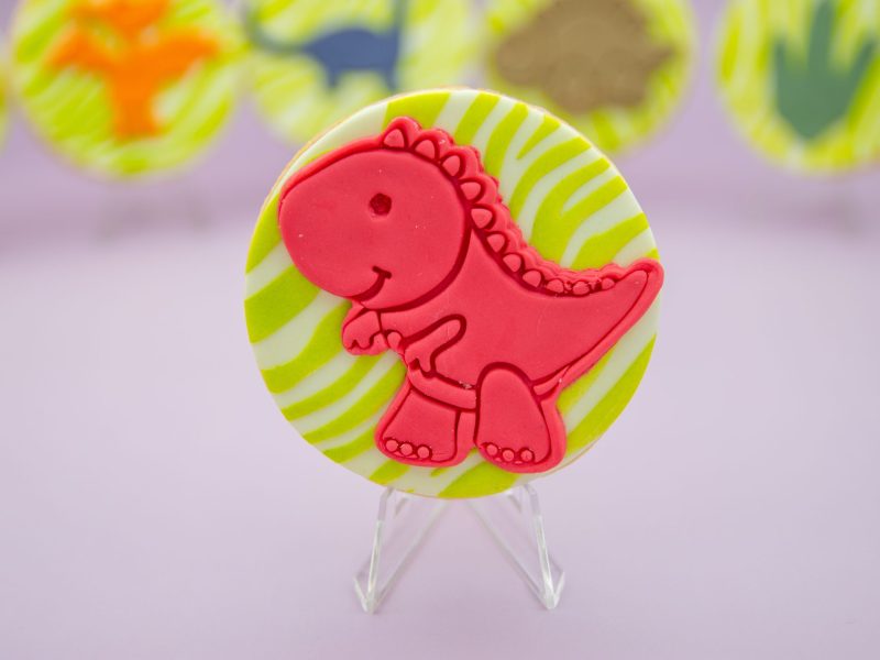 Red T-Rex fondant cookie close-up