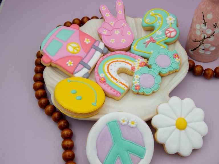 Groovy retro birthday cookies styled with pastel party décor and flowers