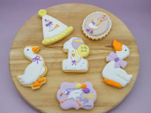 Goose-themed birthday cookies styled with soft pastel decorations