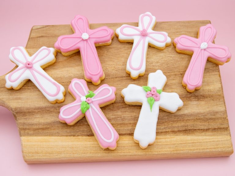 Pink cross cookies laid flat for christening or communion