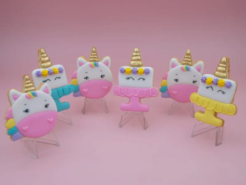 Unicorn birthday cookies standing upright with pastel designs