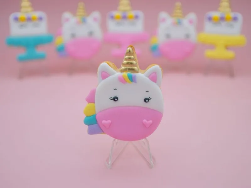 Round unicorn face cookie with pink muzzle and rainbow mane