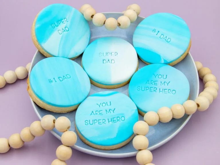 Blue marbled Father’s Day cookies styled with decorations