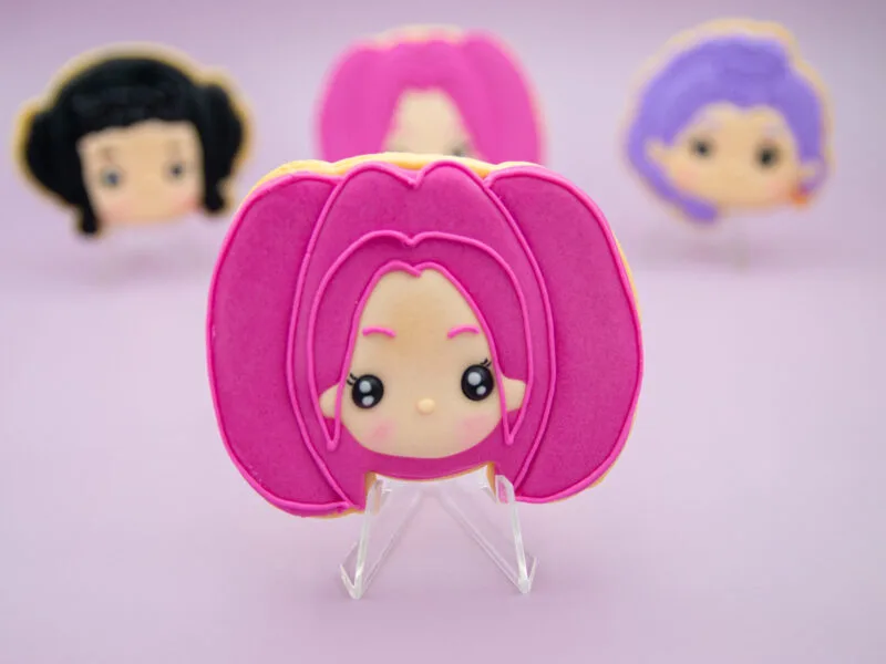 Pink hair Mira Huntrix character cookie with royal icing