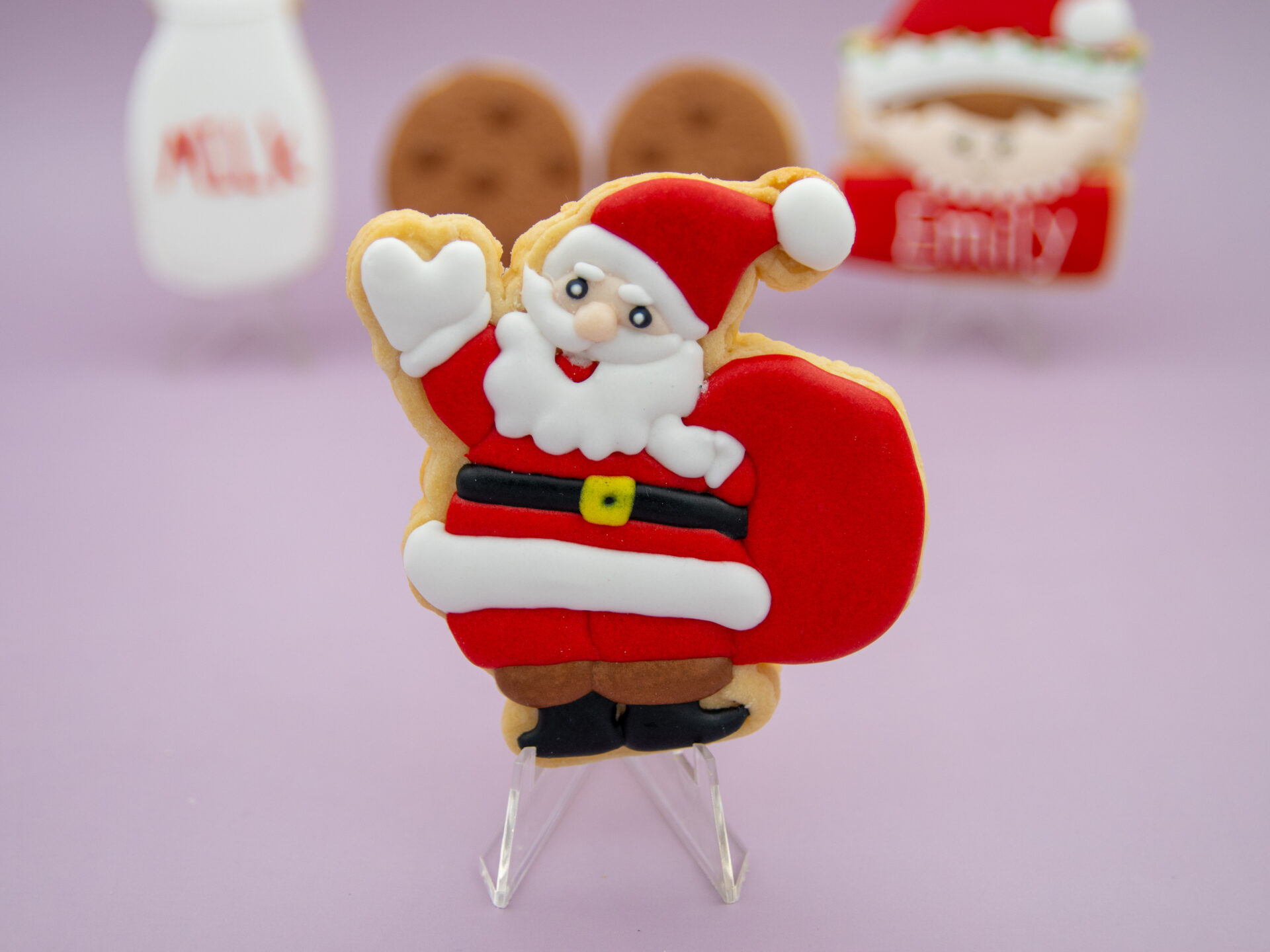 Santa royal icing cookie with red suit and gift bag