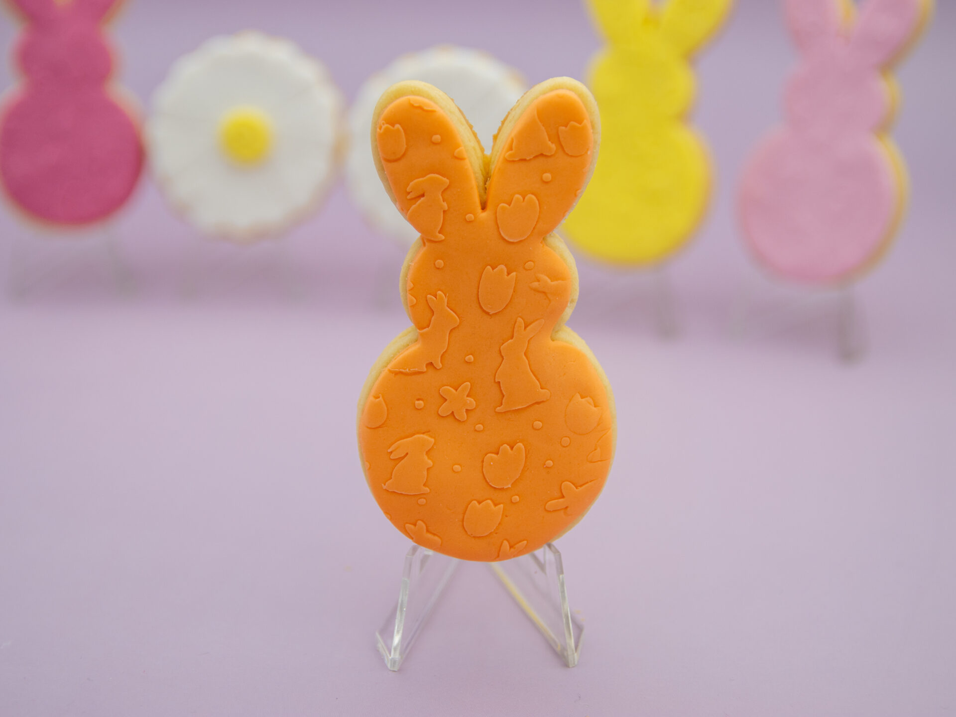 Orange bunny fondant Easter cookie with embossed Easter pattern