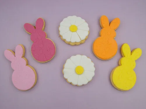 Pastel Bunny & Daisy Easter Cookies flat lay with pastel fondant bunnies and white daisy cookies