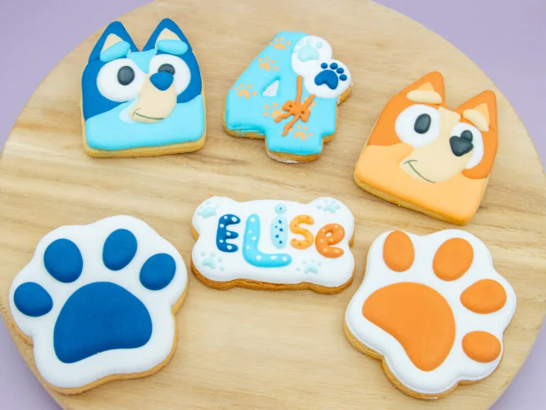 Personalised Bluey Birthday Cookies styled for a kids birthday party with royal icing character and paw print designs