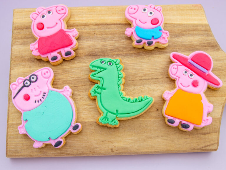 Peppa Pig Family Cookies styled for a kids birthday with fondant character cookies and dinosaur design