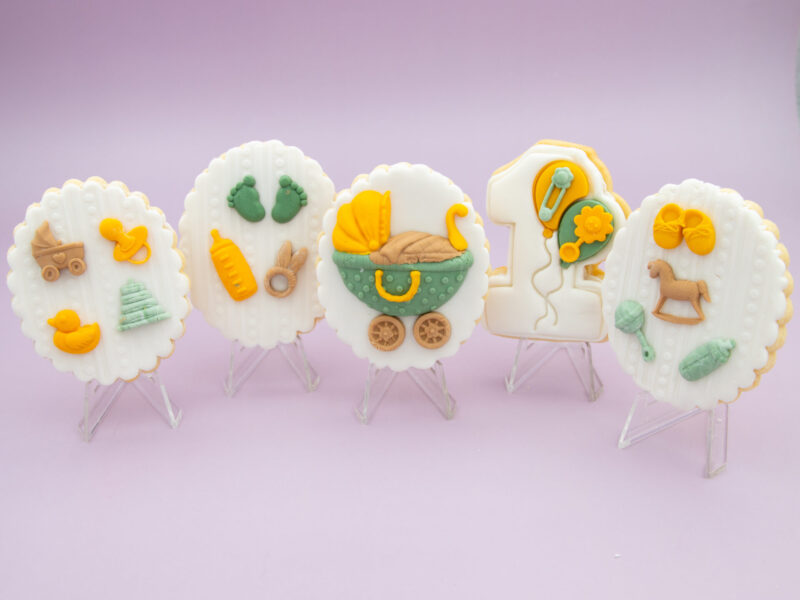 Baby Milestone Cookies standing side by side in a fondant baby celebration set