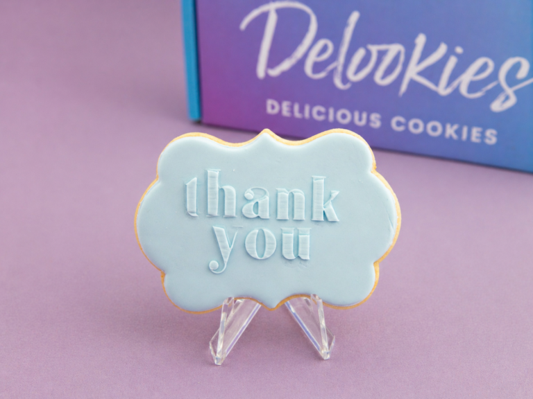 Close up thank you cookie with scalloped fondant shape and raised lettering