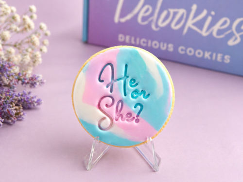 Marbled gender reveal cookies with pastel pink blue fondant and He or She message styled with