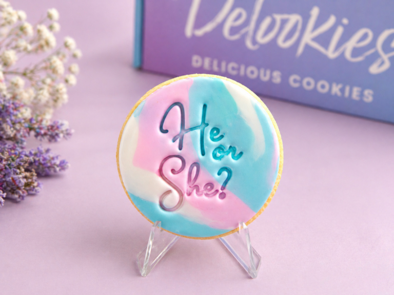 Marbled gender reveal cookies with pastel pink blue fondant and He or She message styled with