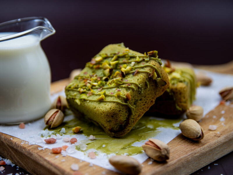 Pistachio Cream Cookie Cubes served with pistachio dip and milk on wooden board