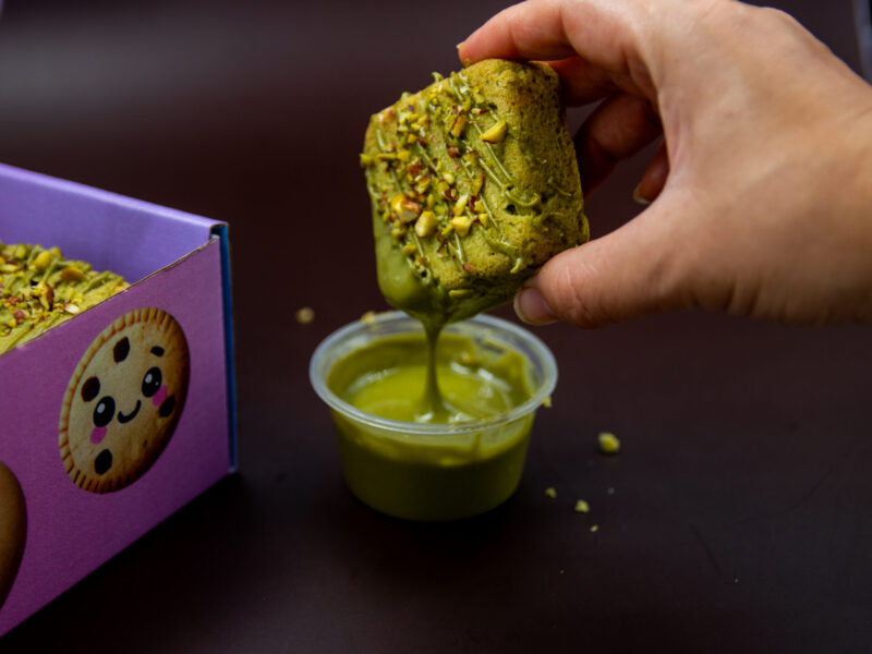 Pistachio Cream Cookie Cube dipped into creamy pistachio dessert sauce