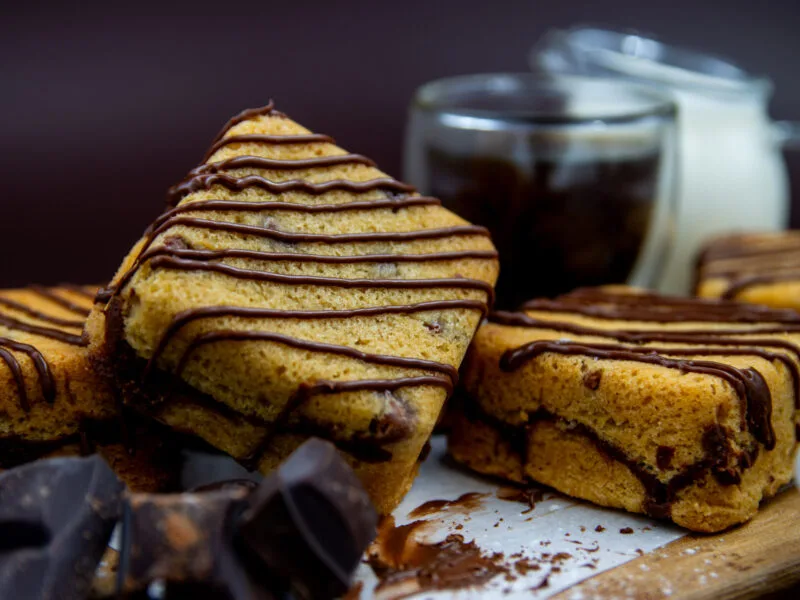 Close up of gooey Chocolate Chip Cookie Cubes with chocolate filling and drizzle