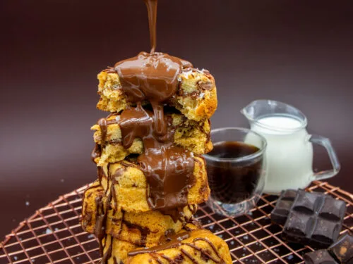 Chocolate Chip Cookie Cubes with chocolate drizzle served with coffee and milk