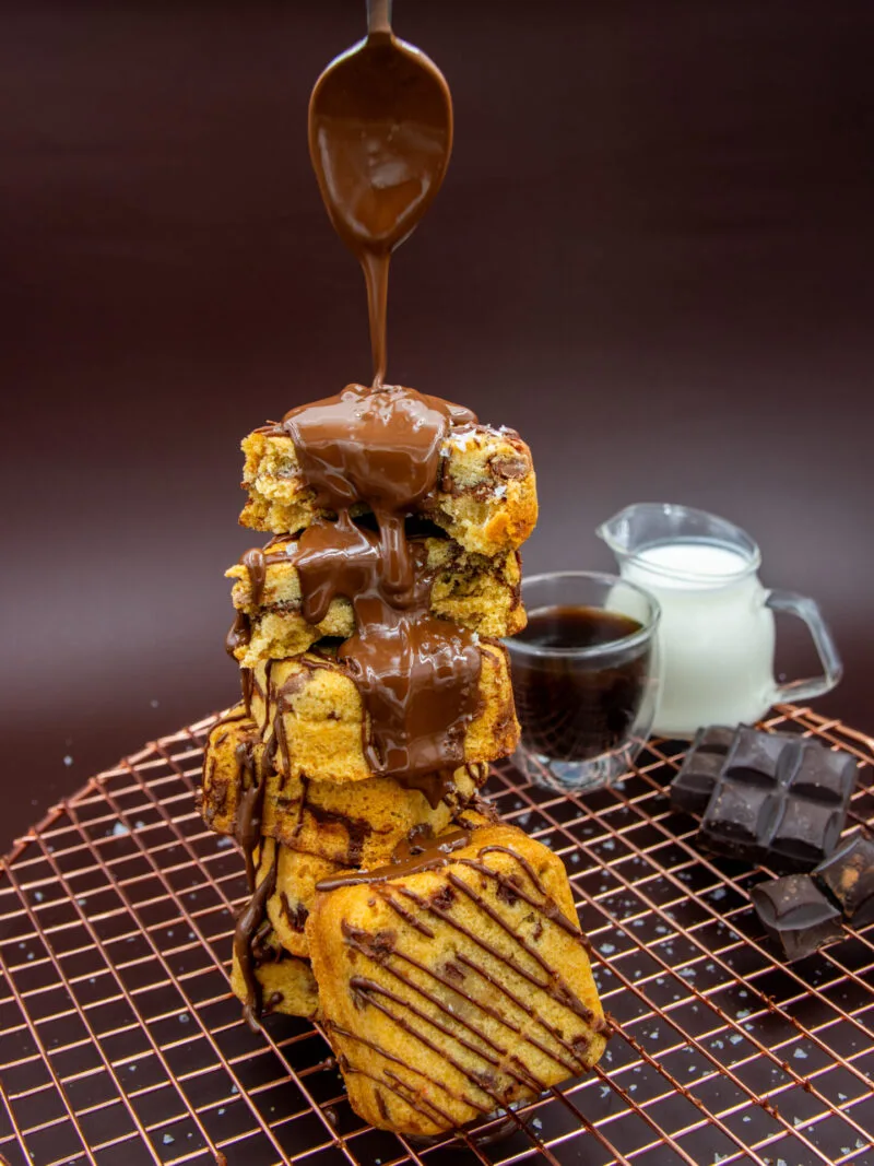 Chocolate Chip Cookie Cubes with chocolate drizzle served with coffee and milk