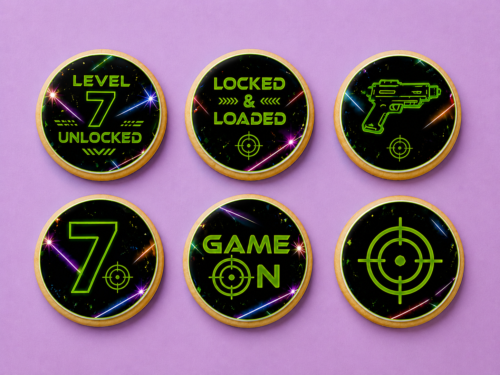 Level 7 laser tag birthday cookies with neon green edible printed fondant designs on purple background